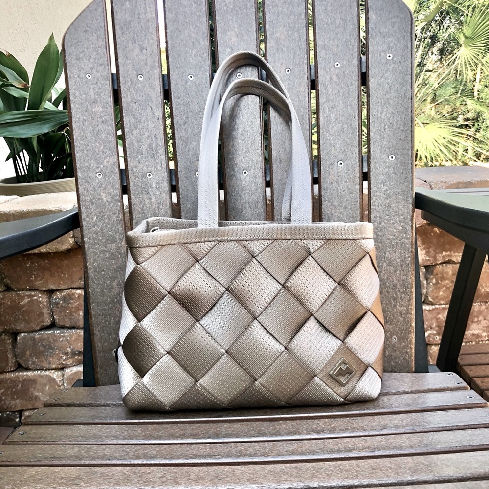 Maggie Bag, tan woven seatbelt, shoulder strap, top zipper.